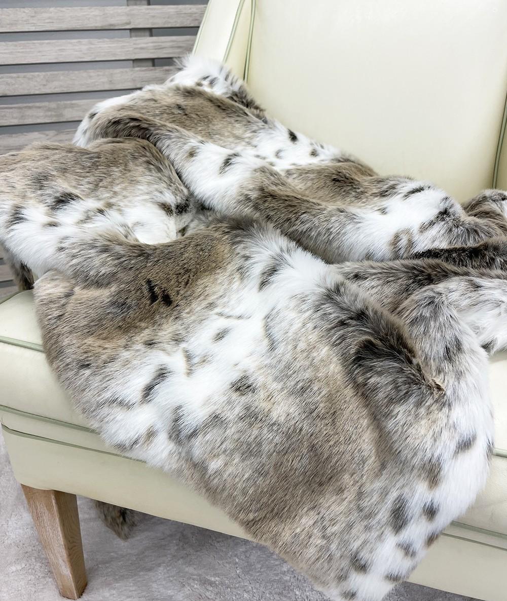 Pale animal print, striped fake fur bedspread or blanket