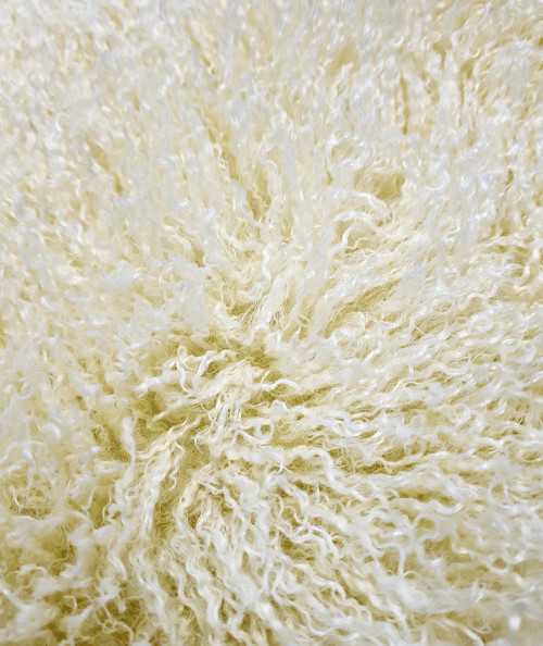 Close up image of the Mongolian curly cream faux fur fabric