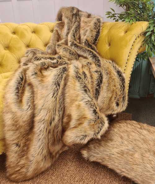 Luxury long-haired beige and brown faux fur sofa throw
