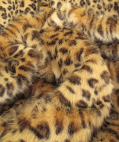 Close up image of the golden leopard print faux fur fabric