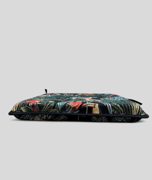 Multi-coloured square chair cushions with a modern rainforest design on a rich black tapestry base